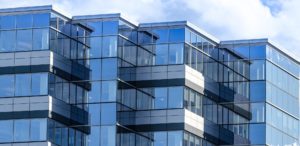 Lines, glass and reflections of modern architecture.  Glass panelled building of new office space in Moncton, New Brunswick.  
New commercial real estate in the city.