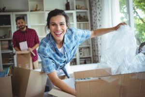 Happy couple unpacking cartons together