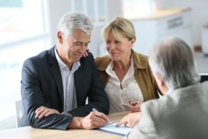 Senior couple meeting real-estate agent for investment